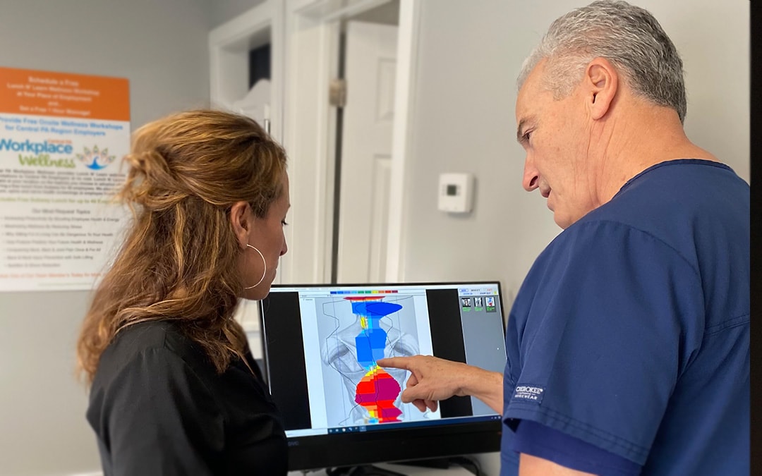 Doctor examining a spinal thermography at Madeira Chiropractic in Hershey, PA